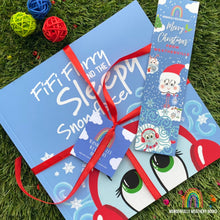 Load image into Gallery viewer, Children&#39;s book titled &#39;Fifi Furry and the Sleepy Snowflake&#39; with a bookmark on a grass background